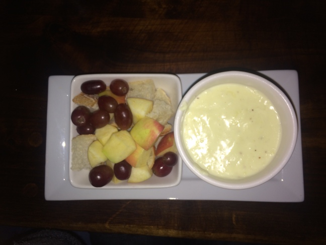 The Fonduemnetal, served with a side of apple chunks, grapes and crusty bread